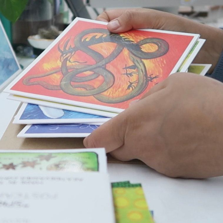 Hand holding colorful cards with a 'Lucky Dip' promotion